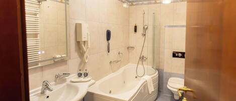 A bathroom with a sink, bathtub, and toilet.