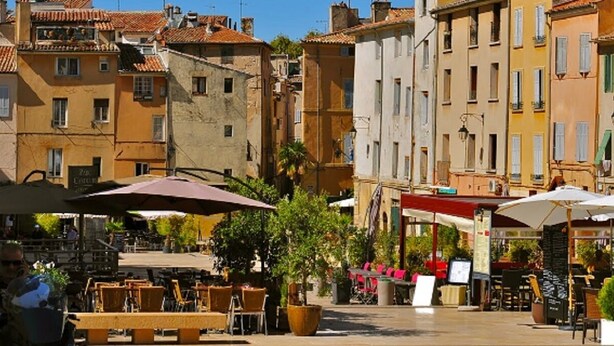 A courtyard with outdoor seating, surrounded by buildings with traditional architecture. - Villa with swimming pool in Pertuis Sud Luberon in Provence (Pertuis)