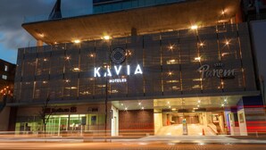 Un moderno edificio de hotel con un letrero destacado que dice "KAVIA HOTELS" y "Panem".