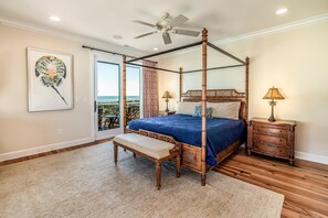 A four-poster bed with a bench, a nightstand, and a lamp. - Creekfront Home with Pool, Dock and Stunning Views (Pawleys Island)