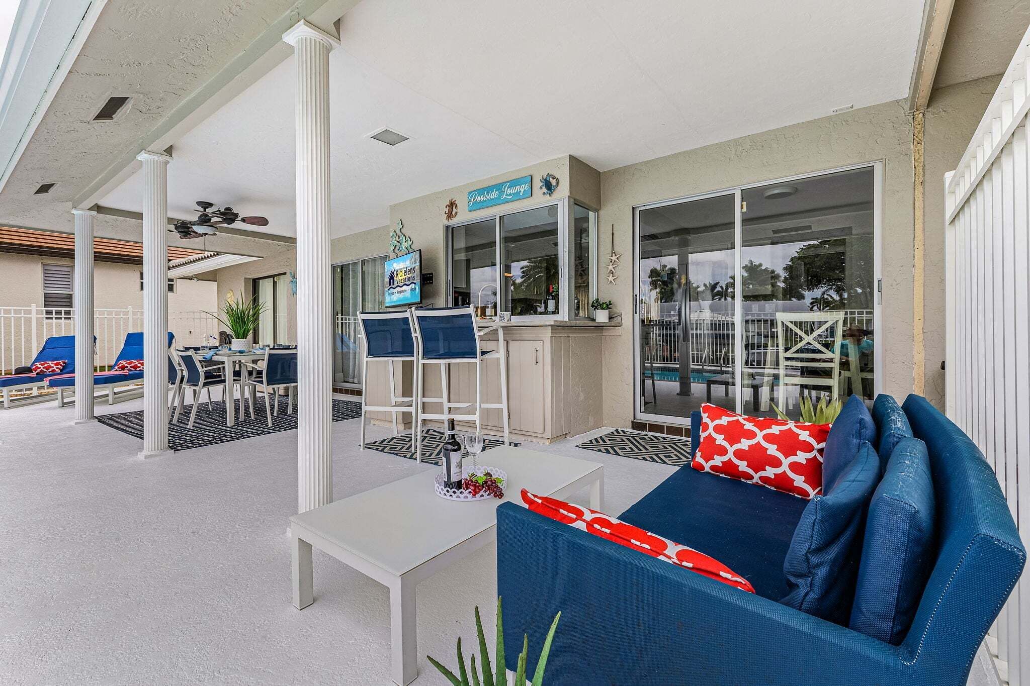 An outdoor patio area with seating, a bar, and a sign for 'Deside Lounge.'