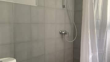 Deluxe Double Room, 1 King Bed | Bathroom | Shower, rainfall showerhead, free toiletries, hair dryer