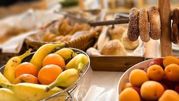 A breakfast buffet with various fruits and bread.