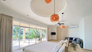 A spacious bedroom with a large bed, a desk, and a ceiling fan. - Beachfront CASA PAAMUL Riviera Maya-Tulum (Paamul)