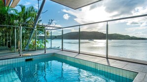 Une piscine avec vue sur un lac et des montagnes.
