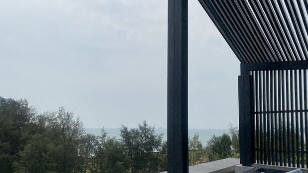 A modern outdoor seating area with a view of the sea. - Hua Hin Condo 200m near beach (Nong Kae)