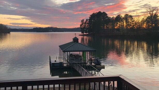 A lakeside view with a dock and a gazebo. - Lakefront home with private beach  & unbelievable sunsets on Lake Keowee (Seneca)