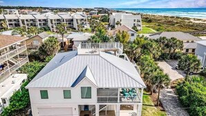 A modern two-story building with a flat roof, a covered porch, and a view of the beach. - Pool, Hot Tub, 50 steps to sand, Pool table (St. Augustine)