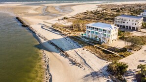 A beachfront property with a large house, a swimming pool, and a beach access walkway. - Paradise Point: Luxury Beachfront Home with Views (Pawleys Island)