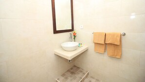 A bathroom with a white sink, a mirror, and two towels hanging on a towel rack. - Brata Cottage Bisma Ubud by Summer Stay (Ubud)