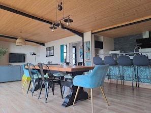 A modern kitchen with a wooden countertop, a built-in oven, and a microwave.