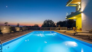 A swimming pool with lounge chairs and a staircase leading to an upper level. - Beautiful home in Vrsi (Vrsi)