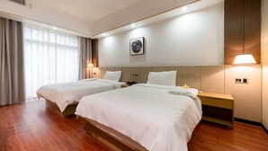 A hotel room with two beds, a wooden floor, a large window with curtains, a wall-mounted picture, and bedside lamps. - Meeteem Boutique Hotel (Baise)