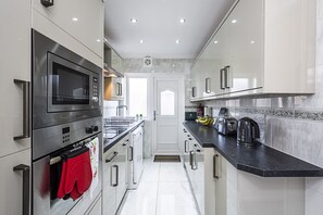 Fridge, microwave, dishwasher, cookware/dishes/utensils - Cozy 3 Bed House in Aveley, Thurrock. (Aveley)