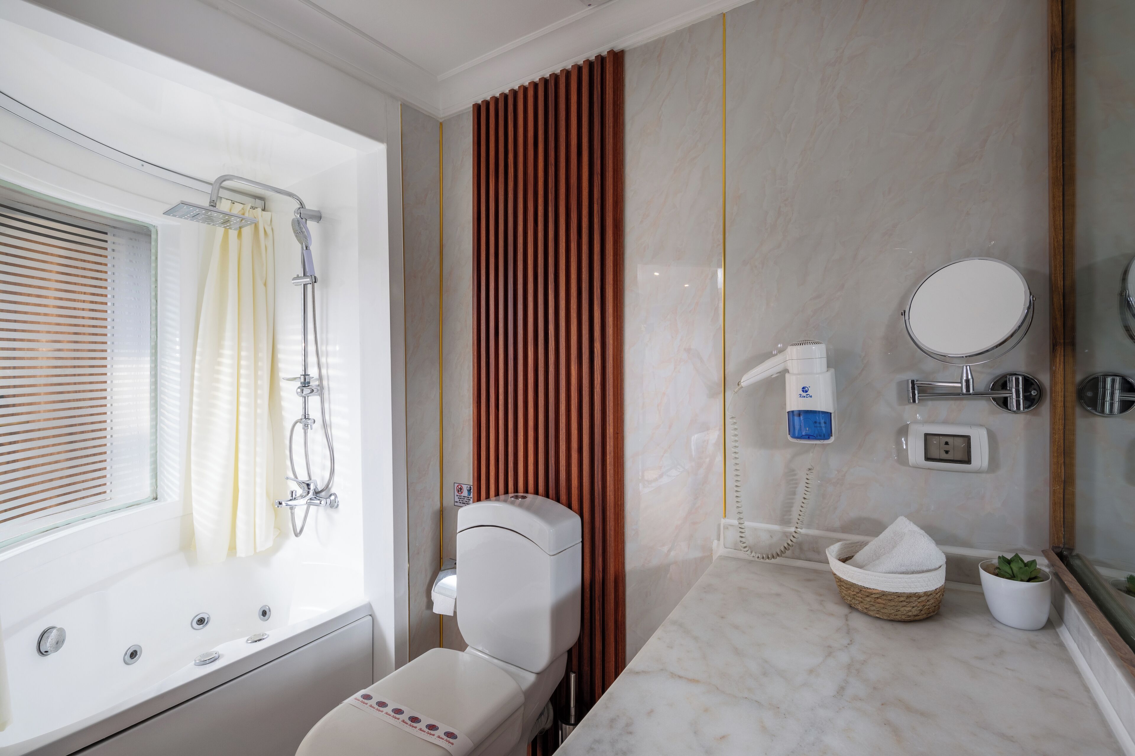 A bathroom with a bathtub, shower, toilet, and a mirror.