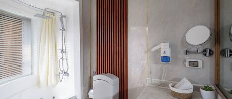 A bathroom with a bathtub, shower, toilet, and a mirror.