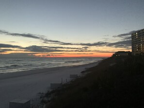 A beach with a sunset, a building on the right, and a clear sky. - *30A Seagrove Highlands Ground Floor Unit- 2 bikes included (Santa Rosa Beach)
