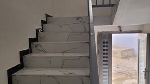 A staircase with marble steps and a metal railing leading to an outdoor area. - Chez Medzo (Toubab Dialao)