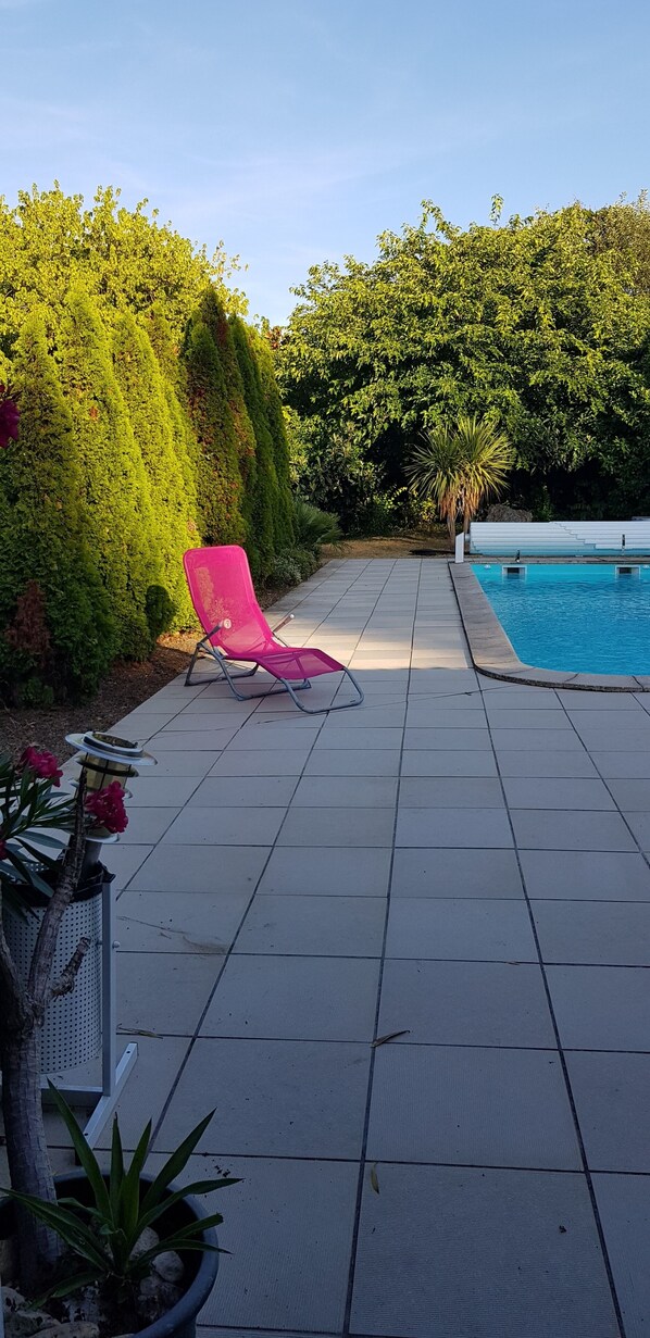 Seasonal outdoor pool, open 9:30 AM to 8:00 PM, pool loungers