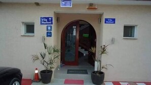 A building entrance with a sign for 'Villa Stefani' and a staircase leading inside.