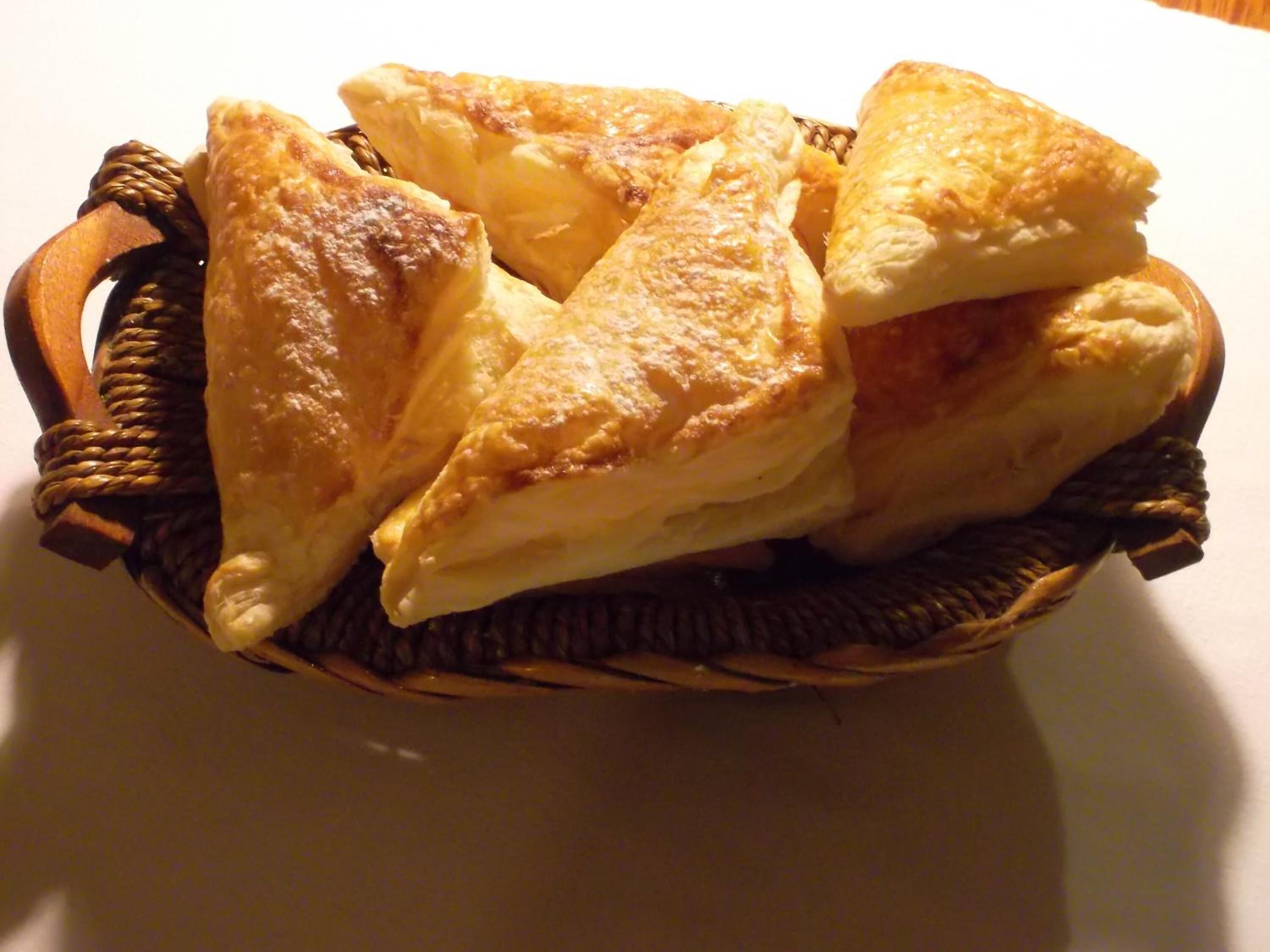 A basket containing several golden-brown pastries.