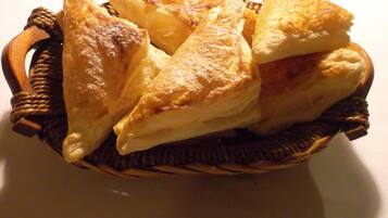 A basket containing several golden-brown pastries.