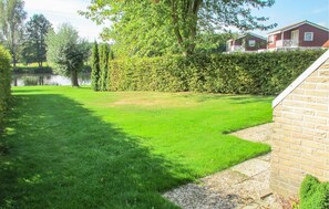 Guests can enjoy serene views of the adjacent pond from this peaceful outdoor space.