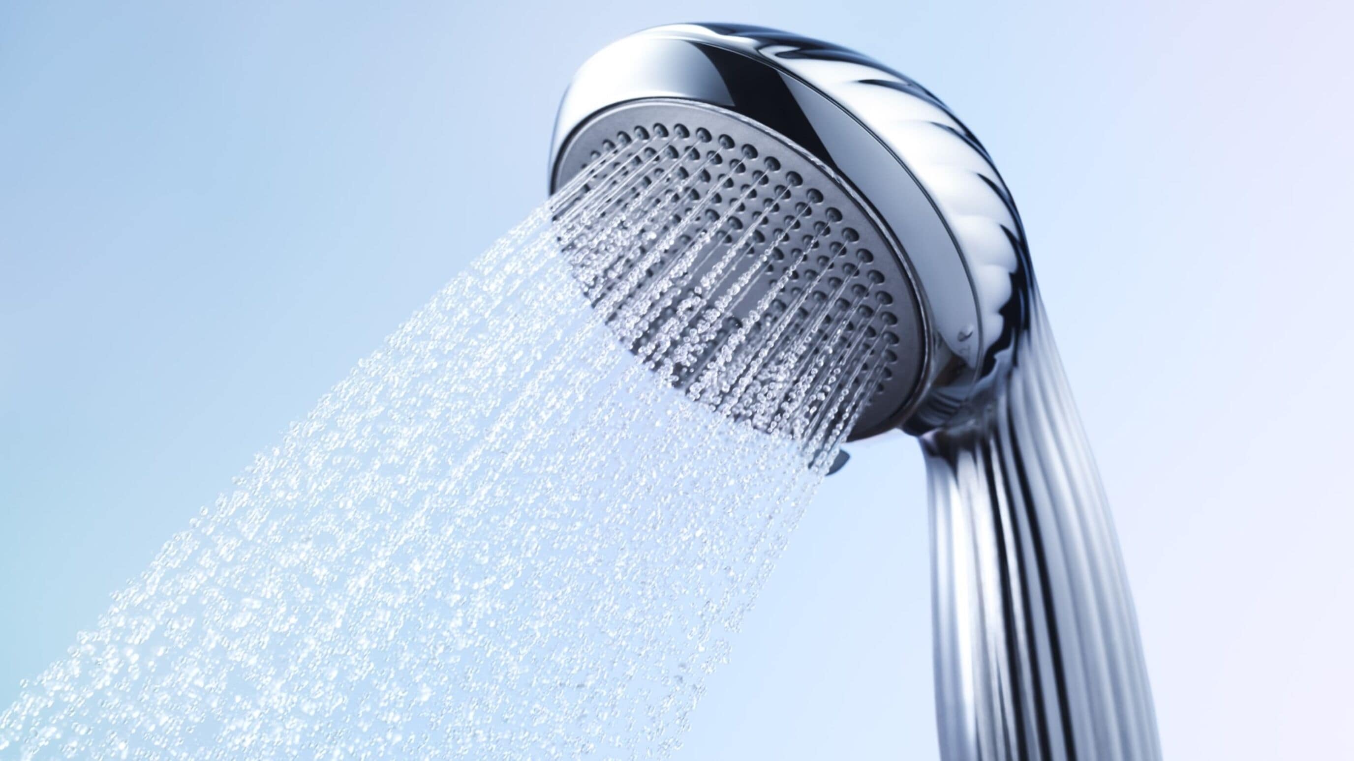 A showerhead with water flowing from it.