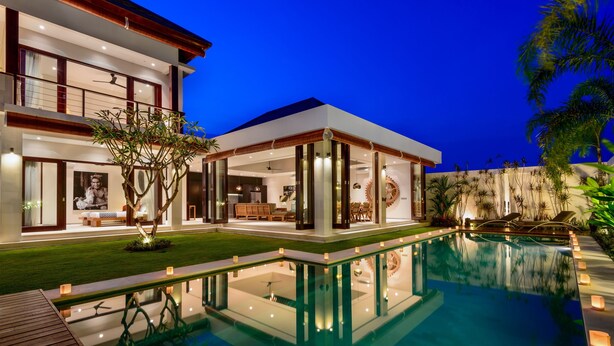 A modern house with a swimming pool, large windows, and a well-lit interior. - Villa The Maya (Canggu)