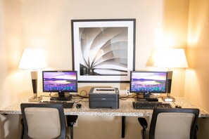 A workspace with two monitors, a printer, and two lamps. - Candlewood Suites Jacksonville - Mayport (Atlantic Beach)