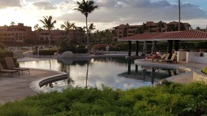 A resort pool area with lounge chairs and a gazebo. - Casa Del Mar Beachnest (San José del Cabo)