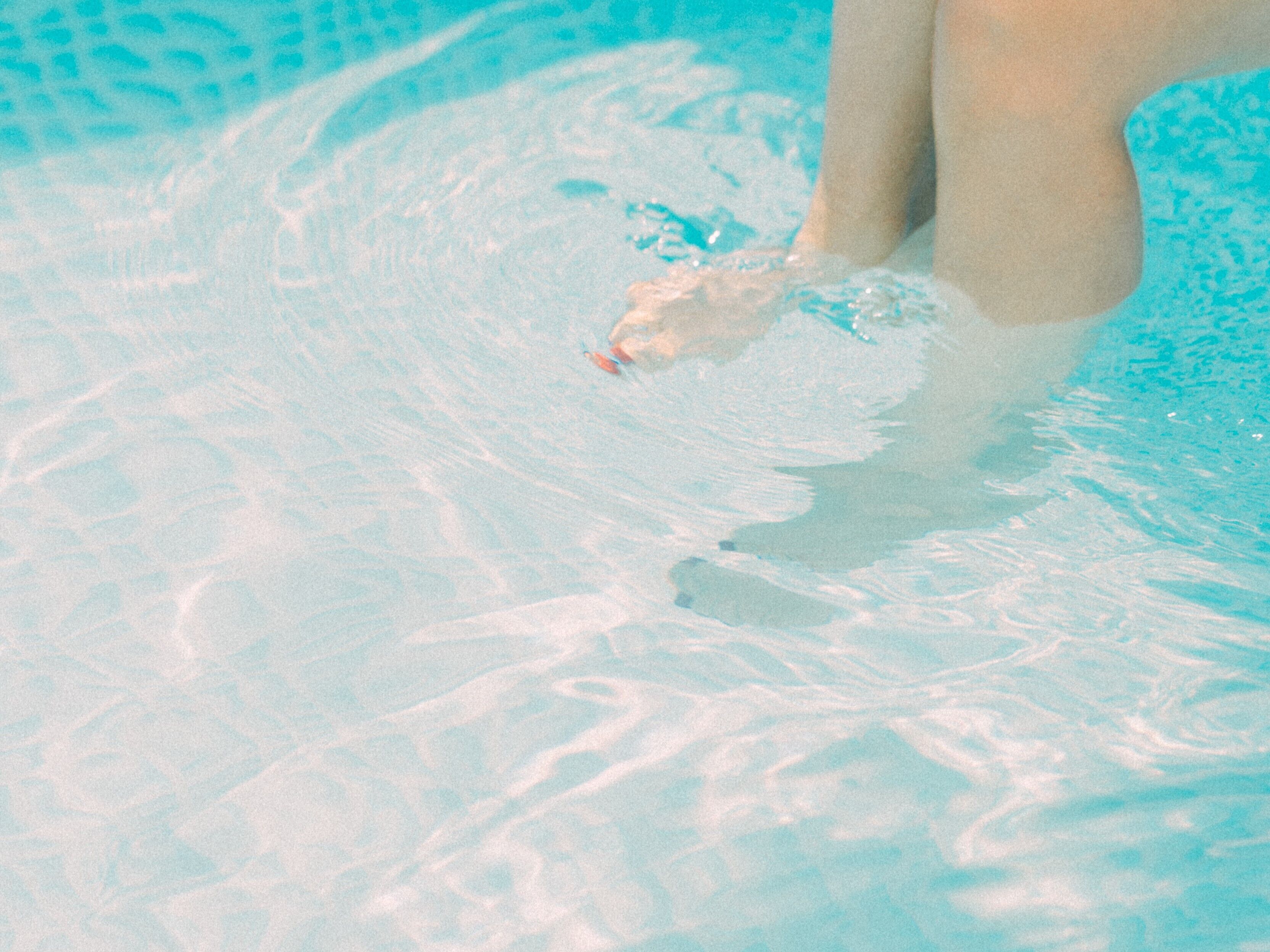 A close-up of a swimming pool with clear water and visible ripples.
