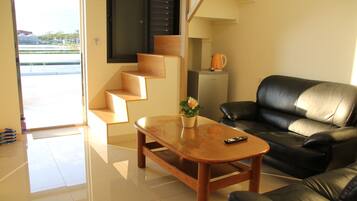 Family Quadruple Room | Living room | Flat-screen TV