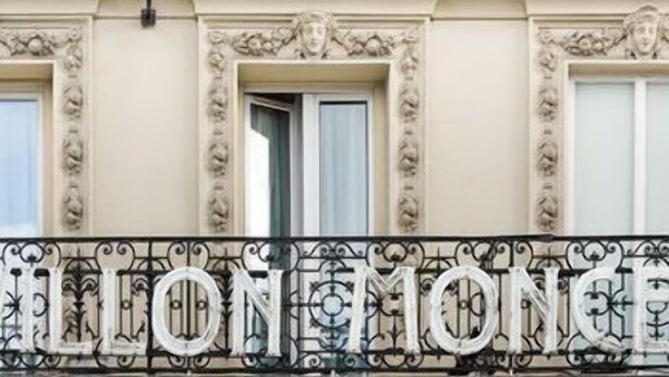 A building facade with ornate architectural details and a balcony with the name 'LION MONCE' in metal letters. - Hotel Pavillon Monceau by Happy Culture (Paris)