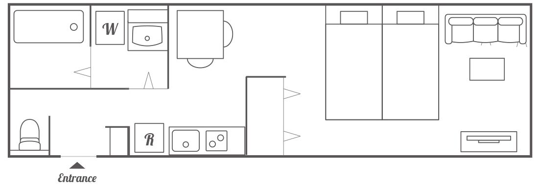 A hotel room layout with a bed, a desk, a wardrobe, a bathroom, and a seating area.