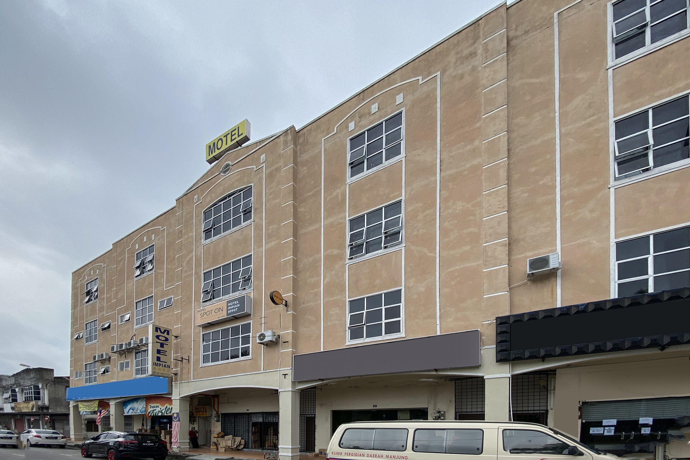 A multi-story building with a sign indicating a motel.
