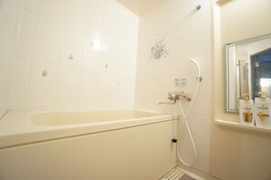 A bathroom with a bathtub, a shower, and a mirror. - Terry's Apartment Shinsaibashi East I G09C (Osaka)