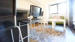 A room with a TV, a desk, a chair, and a window. - Terry's Apartment Shinsaibashi East I G07B (Osaka)