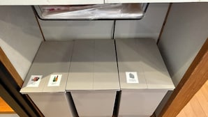 Three grey waste bins with labels for different waste categories. - Tabisai House (Fukuoka)