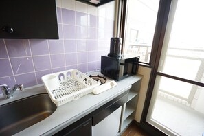 Enjoy cooking in this well-equipped kitchen with a stainless steel sink, coffee maker, and dishwasher.