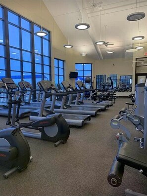 A gym with multiple treadmills and exercise machines, large windows, and ceiling lights. - 5 BR en suite with firepit, hot tub,and game room. (Galena)