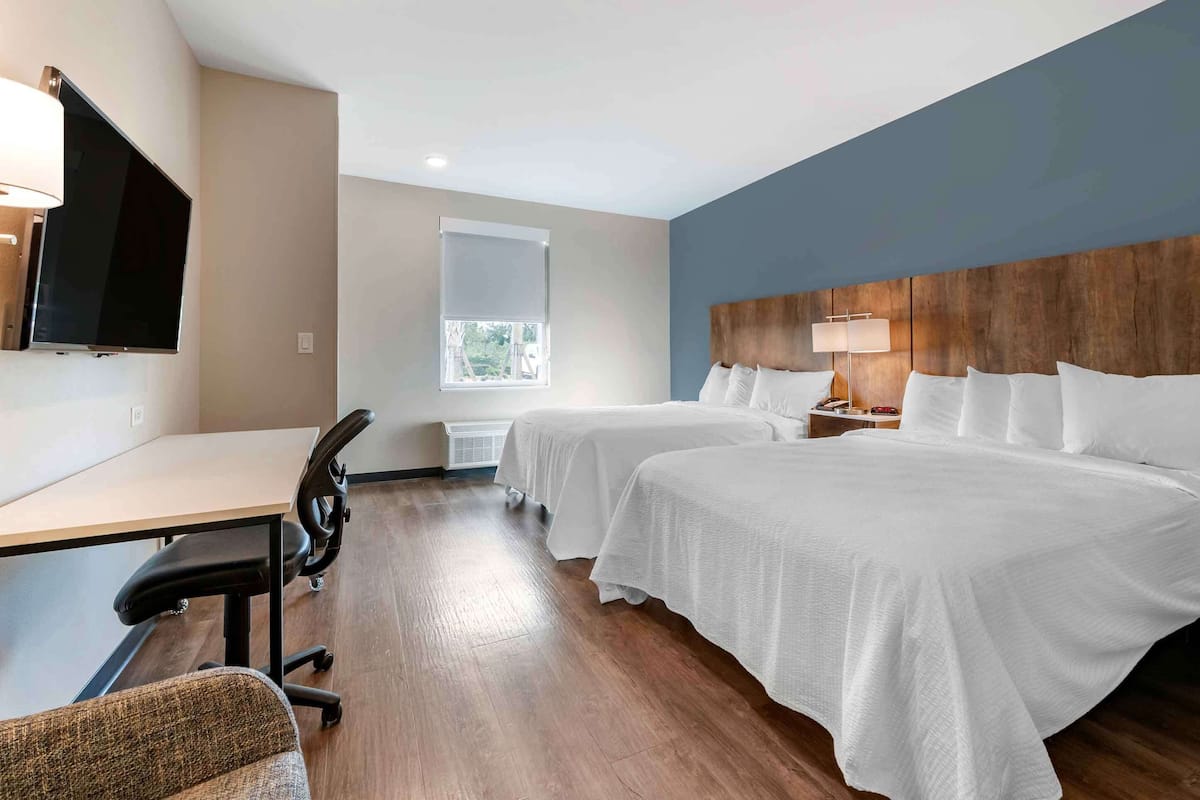 Premium bedding, desk, laptop workspace, iron/ironing board