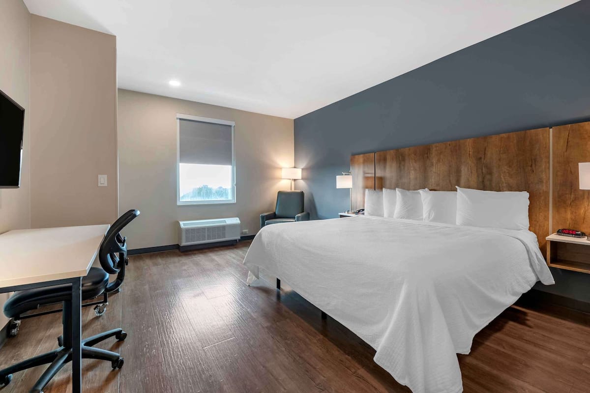Premium bedding, desk, laptop workspace, iron/ironing board