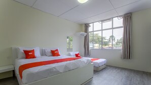 A hotel room with a large bed, a smaller bed, and a window with curtains. - OYO 822 Zande Motel Kuala Selangor (Kuala Selangor)