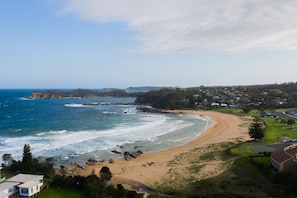 Enjoy the serene coastal views and gentle waves lapping onto the shore.