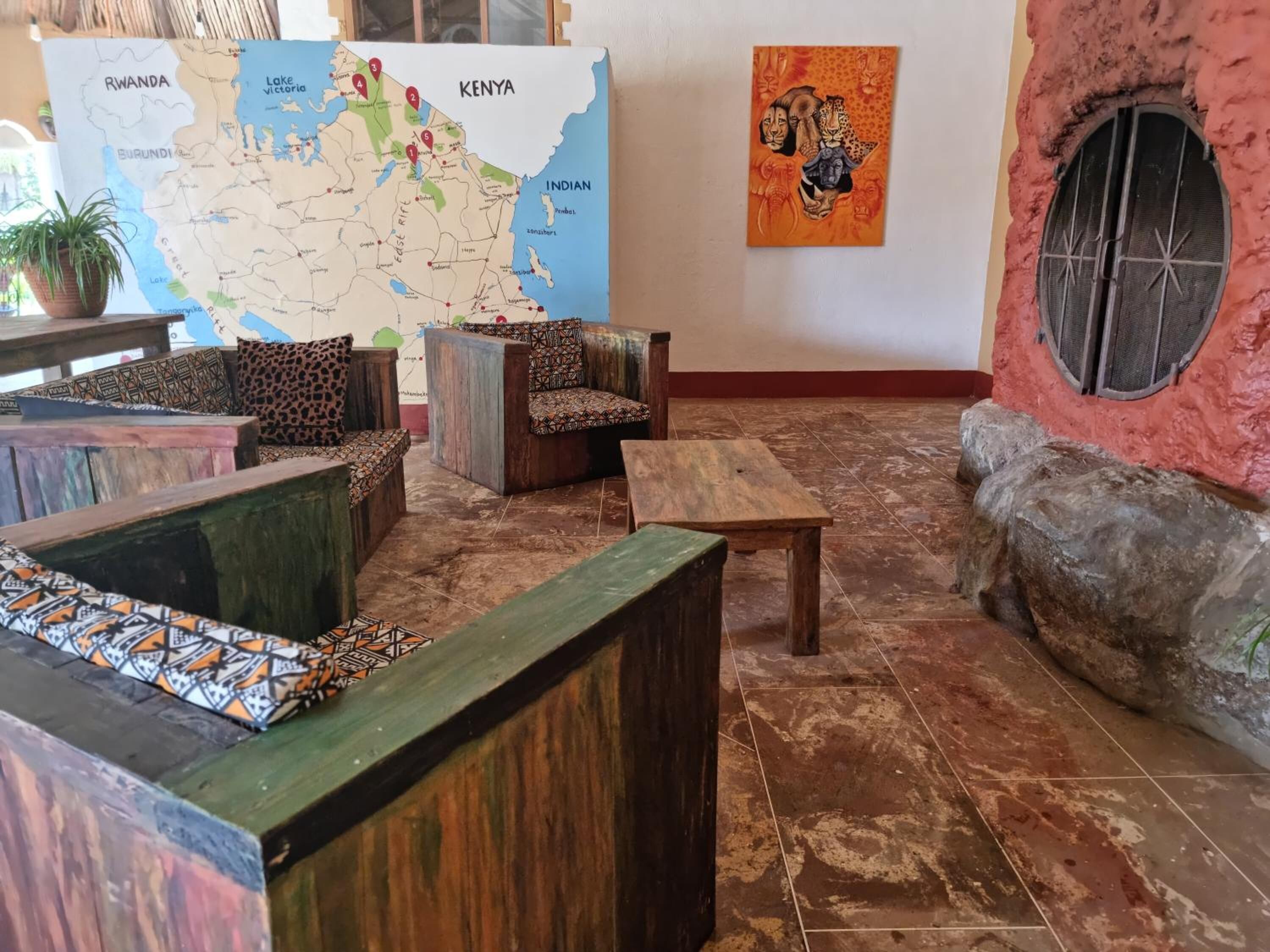 A cozy lounge area with wooden furniture and a map on the wall.