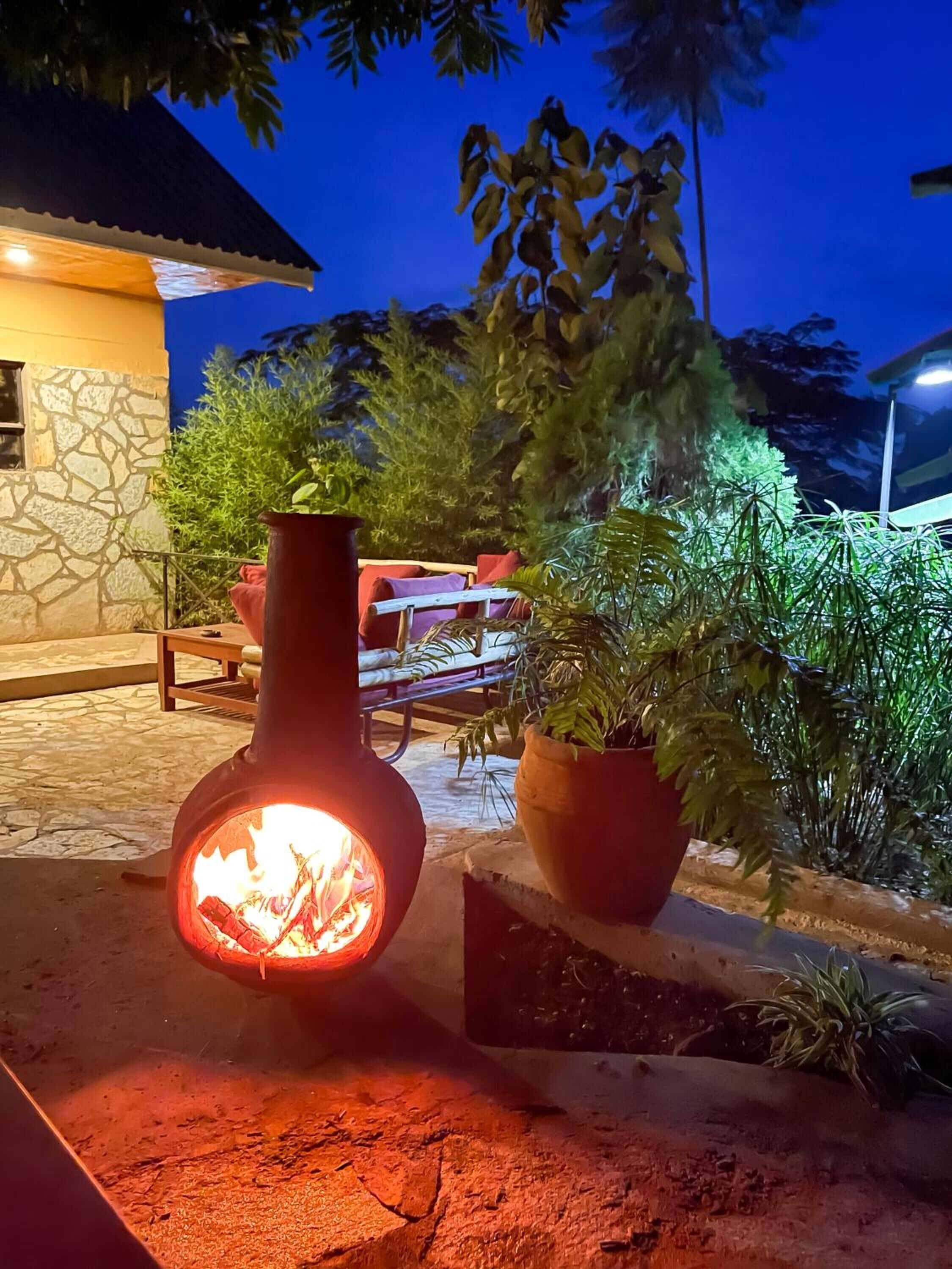 A stone building with a fire feature in the foreground.