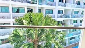 A multi-story hotel with balconies and large windows.