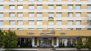 A multi-story hotel with a modern facade, featuring horizontal wooden slats and large windows. - Friendly Hotel (Kyiv)