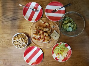 A wooden table with various food items and utensils. - Bovecation House (Bovec)